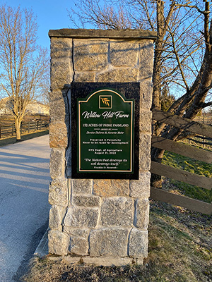 Land Preservation Plaque on stone front gate post